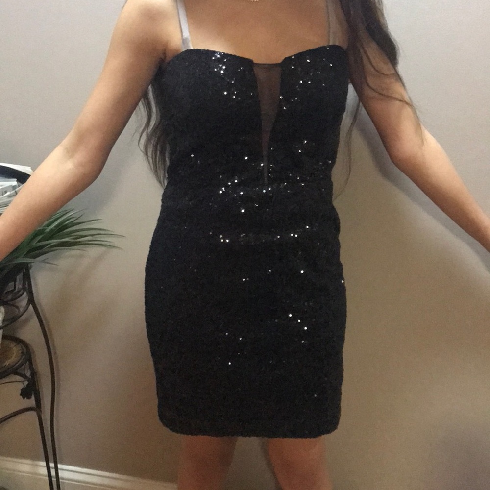 Black sequin dress, zips on the side.